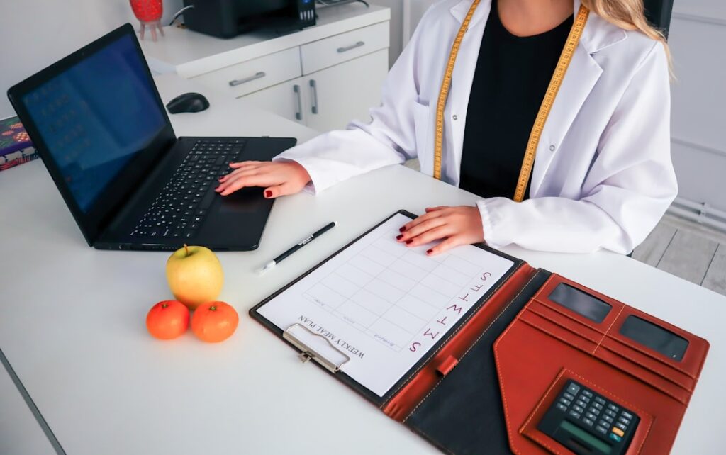 Healthcare professional preparing relocation applications on a laptop